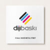 White card featuring a colorful diagonal stripe logo (black, blue, cyan, magenta, yellow) above the gray word mark 'dijibaski' on a white background; below is the caption '0.5mm BAKIR METAL ETİKET'.